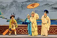 Xu Xian lends Bai Suzhen his umbrella on a ferry boat in West Lake. (Yun opera)