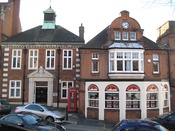 The former fire station (right) now an estate agent, and on the left the former headquarters of Harrow Urban District (now the London Borough of Harrow)