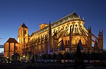 A moderately lit T-shaped cathedral shines at dusk.