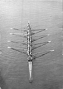 An octuple sculling shell with 16 oars, 8 rowers and a cox in 1907 (Frederick James Furnivall coxing an octuple from the then Hammersmith Sculling Club)