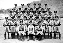 Police officers in summer uniform in 1954. Everything, except for the shorts, was used until 2004 (left), Hong Kong Police Pipe Band performance in Government House (right)