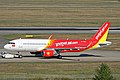 An aircraft of VietJet Air with the national flag painted below the windshield. The yellow-star-on-the-red-background symbolism of the Vietnamese flag is also used to decorate the engine.