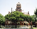 Gonzales County Courthouse. One of the first examples of Gordon's Signature style, featuring corner entrances and an atrium, the Second Empire-style building, built to drawings made in 1890, was placed on the National Register in 1972.