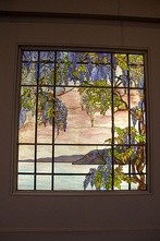 Left to right: View of Oyster Bay (1908), by Louis C. Tiffany, with wisteria evoking the estate of its patrons, Wistariahurst; Japanese wisteria and white-bellied green pigeons (1883), a woodblock print by Kōno Bairei