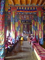 Left: Steps up to recent extensions to the monastery. (2004) Right: Maitreya Buddha in the hall