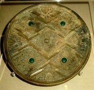 A late Zhou or early Han Chinese bronze mirror inlaid with glass, perhaps incorporated Greco-Roman artistic patterns