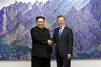 North Korean leader Kim Jong-un and South Korean President Moon Jae-in shake hands inside the Peace House.