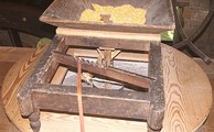 "Slipper" feeding corn into the grindstones of George Washington's Gristmill