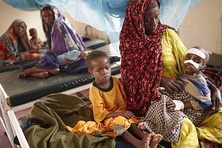 Clockwise from top left: a homeless man in Toronto,  Canada; a disabled man begging in the streets of Beijing, China; waste pickers in Lucknow, India; A mother with her malnourished child in a clinic near Dadaab, Kenya;