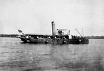 Submarine minefield service vessel "Miner" with cylindrical mines and connecting cables hanging over side. [gallery 7]