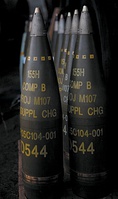 M107 artillery shells. All are labelled to indicate a filling of "Comp B" (mixture of TNT and RDX) and have fuzes fitted