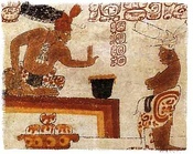 A Maya lord sits before an individual with a container of frothed chocolate.