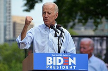 Photo of Biden raising his fist while while standing behind a lectern