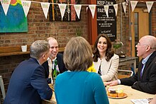 Catherine and William talking to people over lunch