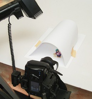 Improvised small infinity cove used to photograph a model of a drinking penguin character.