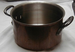 A copper saucepot (stainless lined, with cast iron handles)
