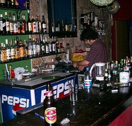 A bartender at work in a pub in Jerusalem