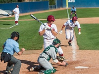 A Loyola Marymount baserunner attempts to steal home during a 2011 college baseball game in Los Angeles.
