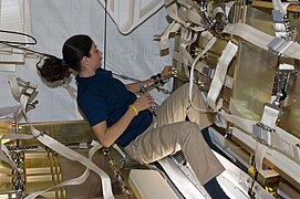 NASA astronaut Nicole Stott working inside HTV-1 8 days later, with some supplies already removed.