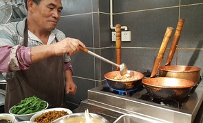 Mixian (米线) rice noodles being cooked in copper pots (铜锅), China