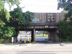 A freight train crossing a railway bridge at the south end of Scarlett Road