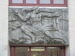 A relief of Prometheus giving fire to humanity on the facade of Remsen Hall.