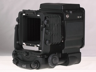 Most of the camera controls and a flash synchro socket are on the right side of the body, shown here with a 1m remote release. This is a bare body with bellows only; the revolving film holder would lock on to the prominent circular interface.
