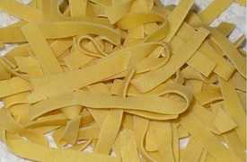 Wide, uncooked egg noodles