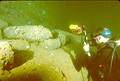 Diver photographing 14-inch artillery shells in the Yamagiri Maru