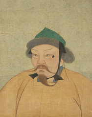 Portrait of a man with a long thin beard and mustache, wearing an orange robe and a small green hat with fur.