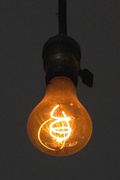 An incandescent light bulb's filament emitting light