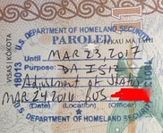 Parole stamps applied by United States Customs and Border Protection officers to the passports of two foreign nationals, indicating they were allowed to enter the United States because of Advance Parole permission previously issued by United States Citizenship and Immigration Services.  Handwritten annotations indicate that the stamp on the left was issued at John F. Kennedy International Airport in January 2017 under the Deferred Action for Childhood Arrivals (DACA) program, and the stamp on the right was issued at Logan International Airport in March 2016 for an adjustment of status applicant.