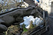 A gargoyle on the Basilique du Sacré-Cœur, Paris, France, showing the water channel