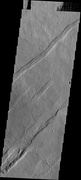 Oti Fossae, as seen by THEMIS. These parallel graben are found on the northeastern side of Arsia Mons; they are in line with the NE/SW trend of the three volcanoes in Tharsis.
