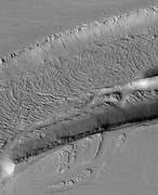 The Olympica Fossae, as seen by HiRISE. Click on image to see rock layers in wall. Image is located in Tharsis quadrangle.