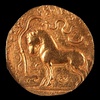 Samudragupta coin with horse standing in front of a yūpa sacrificial post, with legend "The King of Kings, who had performed the Ashvamedha sacrifice, wins heaven after conquering the earth".[7][8]