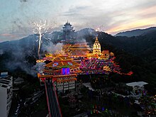 Temple at night illuminated with light from decorations