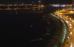 Night view of the boats docked to the east shoreline of Al-Khan Lagoon