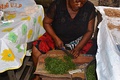 A woman slicing Eru leaves