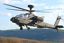 Helicopter in flight above heathland