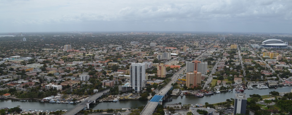  Aerial view of Little Havana, Miami River foreground, Marlins Park to the right, Coral Gables skyline in background, Coconut Grove and Biscayne Bay to the very left.