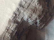 Layers from numerous lava flows are exposed on the side of a pit on the lower west flank of Arsia Mons (photo by HiRISE).