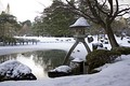 Snow lanterns, like this one in Kenroku-en garden, have wide brims which catch the snow, to create picturesque scenes.