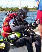 Technical diver with back mounted open circuit scuba and sling mounted decompression cylinders