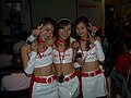 Women in white and red PVC skirts and tops