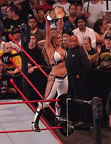 Trish Stratus celebrating her victory as a 7-time WWE Women's Champion in her retirement match in Toronto.