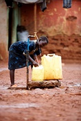 WASH consists of water, sanitation and hygiene, in clockwise order from top left: A woman pumps water from a handpump in her village in Sindh, Pakistan; A girl collects clean water from a communal water supply in Kawempe, Uganda; a simple hand washing setup for when there is no running water, shown in Omaruru, Namibia; school toilets at an elementary school in Boquete, Panama.