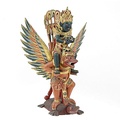 Balinese wood carving from Indonesia, depicting Vishnu mounting Garuda