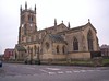 A large stone church with a battlemented clerestory and a pinnacled tower