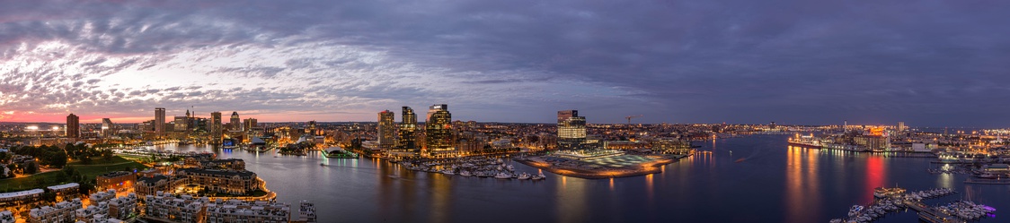  A panoramic view of Baltimore in September 2016, including the Inner and Outer Harbors at dusk, seen from HarborView Condominium